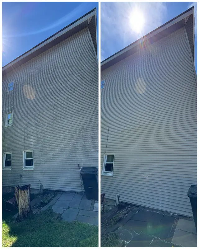 Before and after soft washing comparison on a tall exterior wall